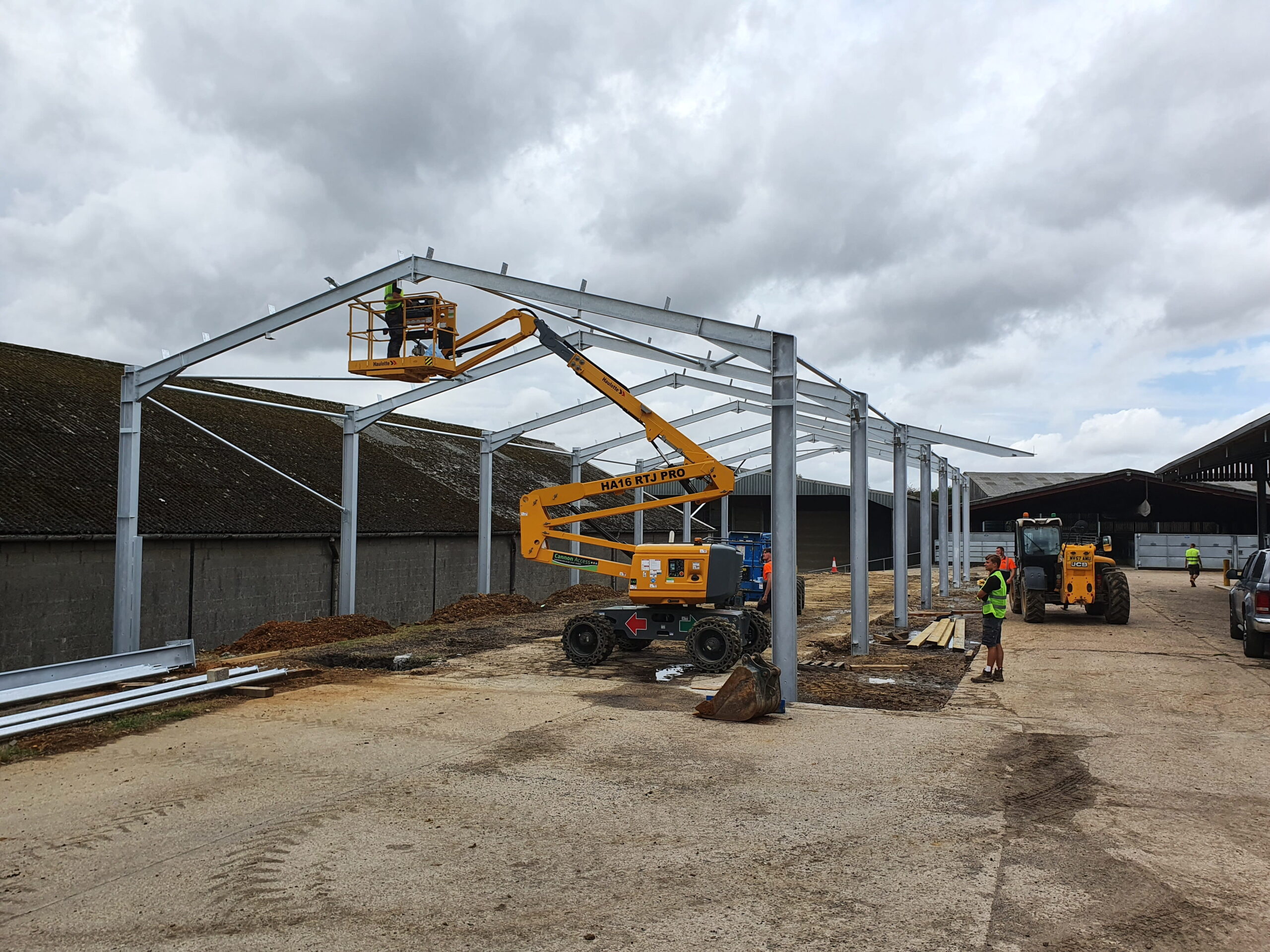 the foundations and metal frame of the cattle shed being put in place