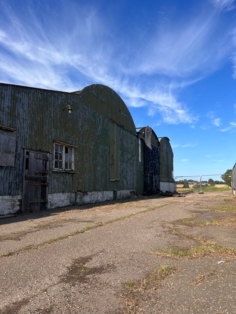 Old barn with curved roof prior to refurbishment