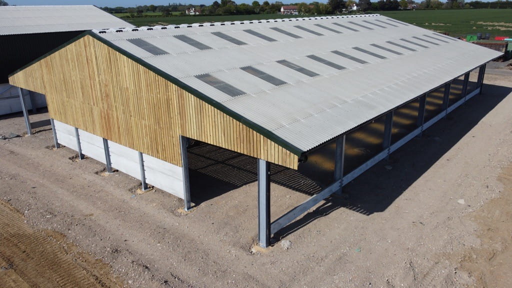 Side view of the livestock shed showing the concrete panels ready for the installation of a feed fence